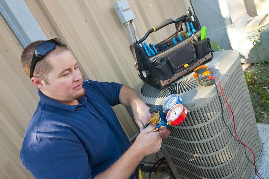 technician checking external HVAC unit