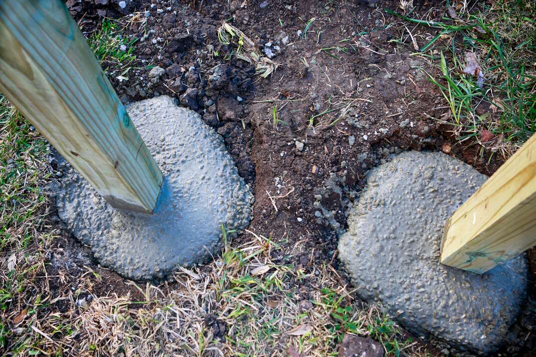 Wooden fence post in concrete