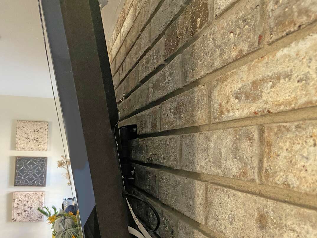 tv mounted into masonry