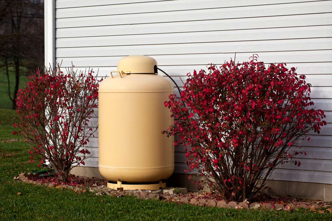 Large Propane Tank situated alongside a residentual home.