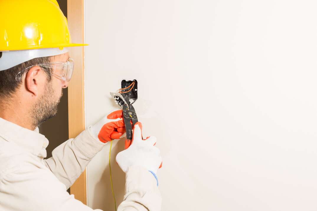 Electrician placing a light switch in a house