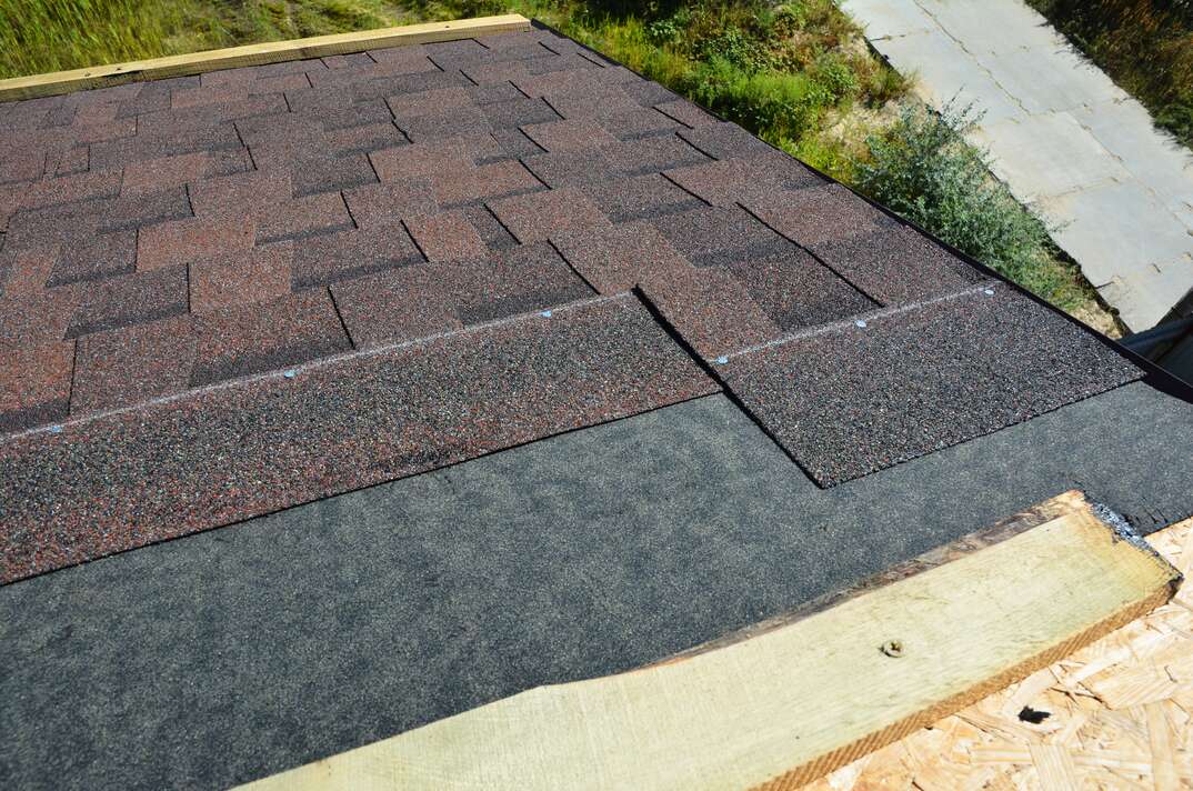 Laying and installing asphalt shingles  House Roof asphalt shingles repair  Roofing construction with roof tiles, asphalt shingles 