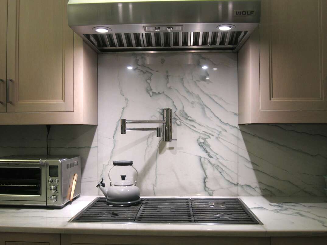 Wolf stovetop and range hood with pot filler on wall