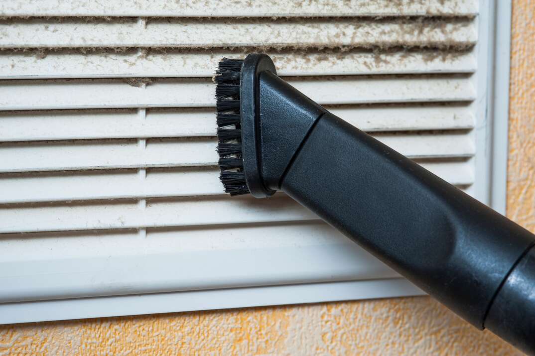 vacuuming window blinds