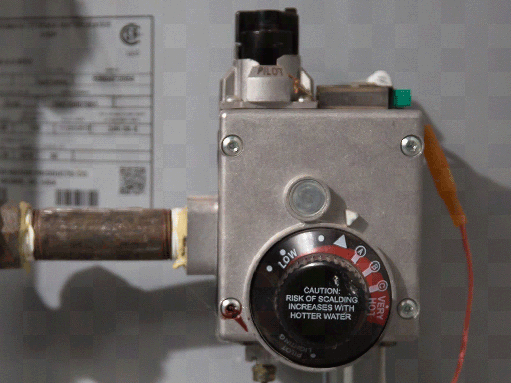 a close up of a gas water heater s temperate control knob as it animates the temperature rising up and back down 