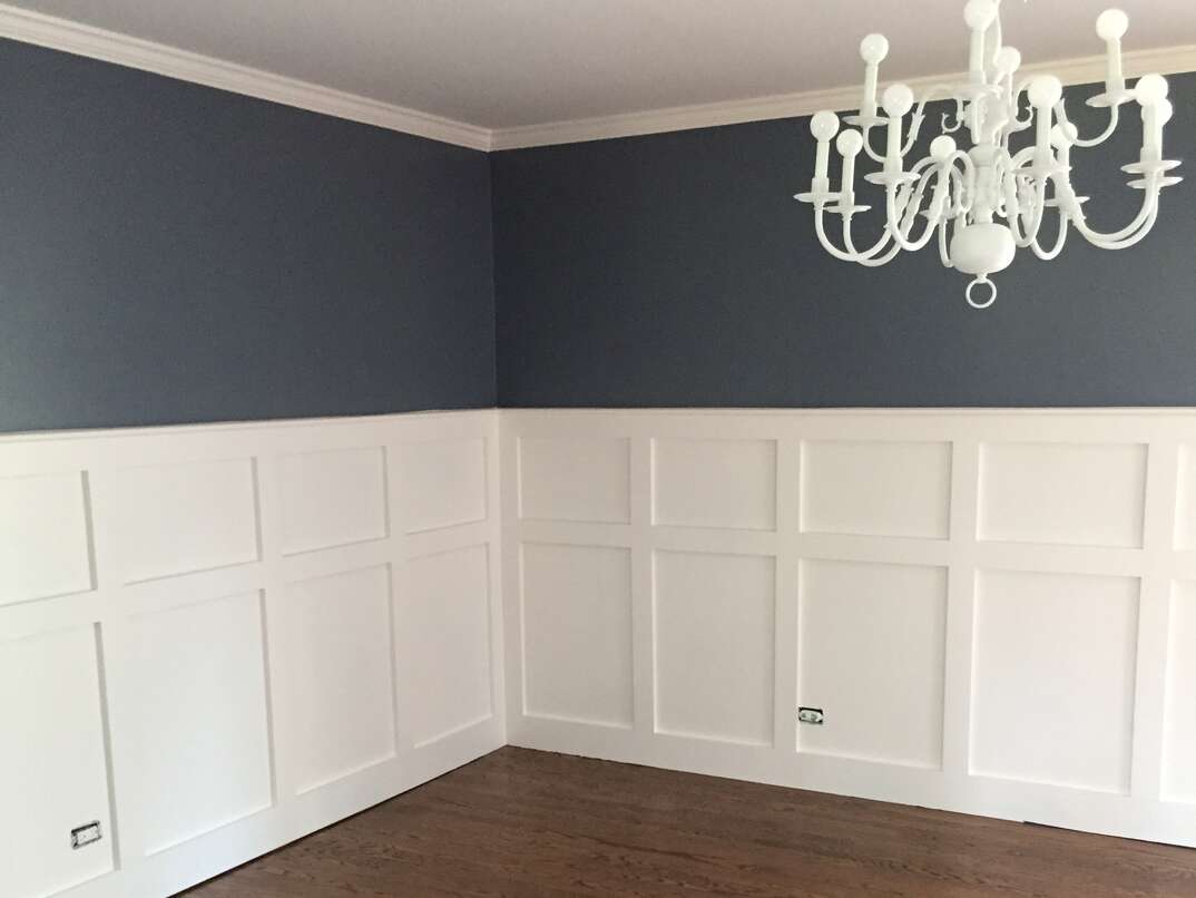 A formal dining room with finished Wainscoting