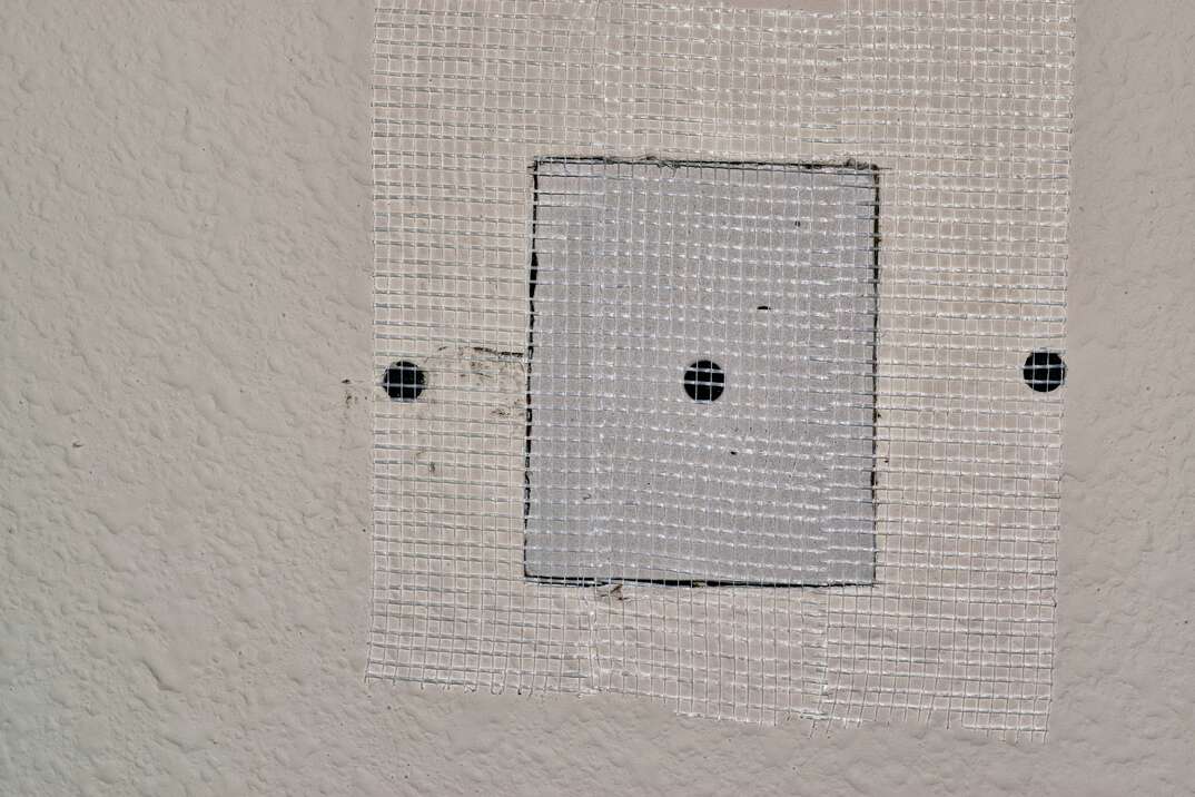 Drywall repairs in wall with fiberglass tape 