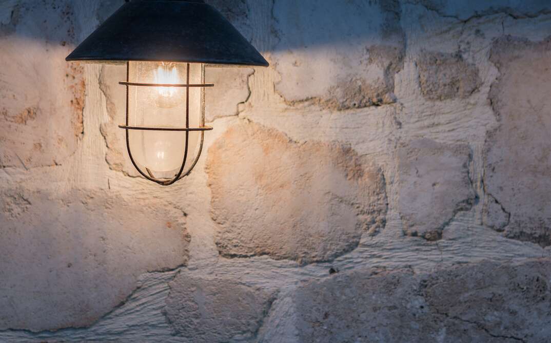 Light bulb on the stone wall 