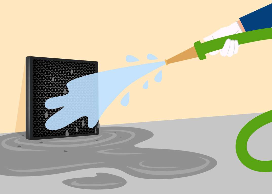 illustration of spraying down an electrostatic furnace filter with a hose