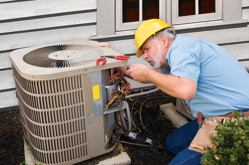 technician checking external HVAC unit