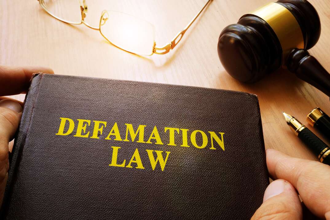 book on a desk that says defamation law