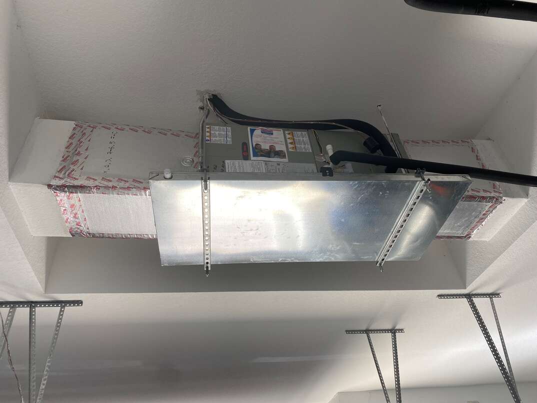 a new ceiling mounted air handler hangs in a new Florida home
