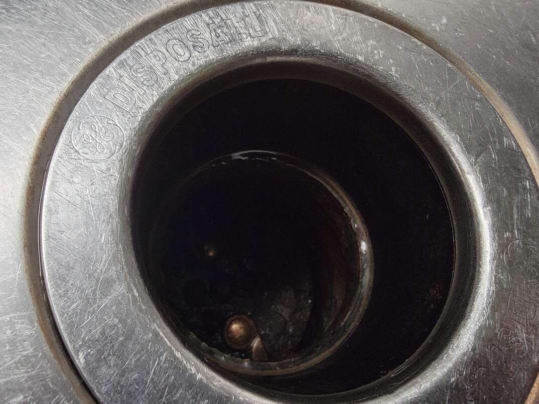 close up of a sink s garbage disposal