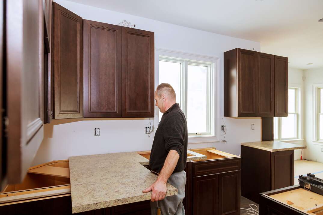 Contractor installing a new laminate kitchen counter top