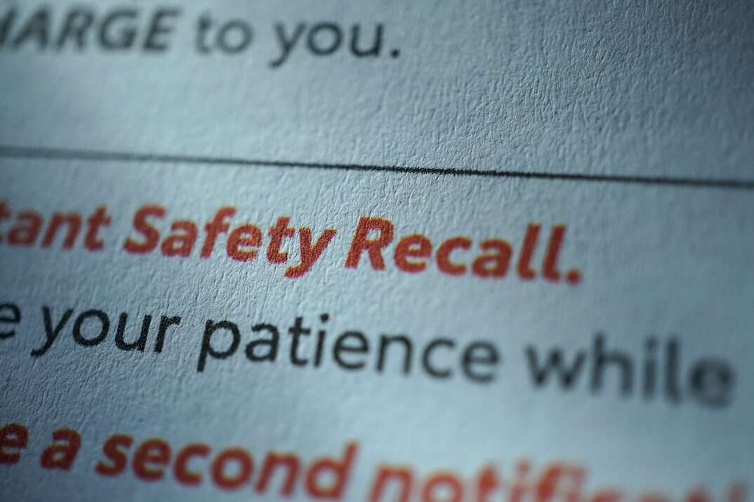 image shows an extream close up of text from a book or magazine that has black text and the words Safety Recall in red text 