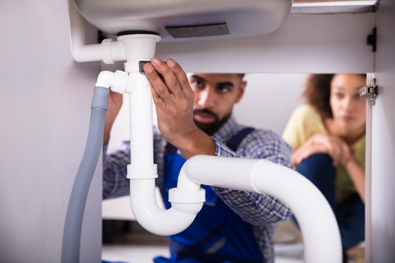 plumber fixing faucet