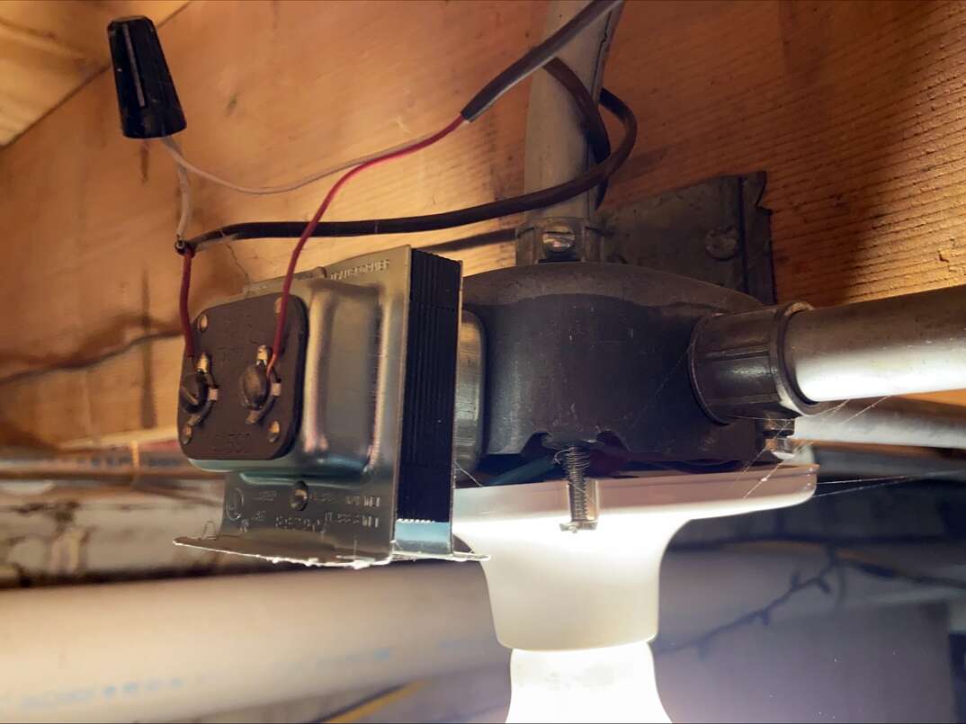 close up of a residential doorbell transformer mounted to an electrical junction box.