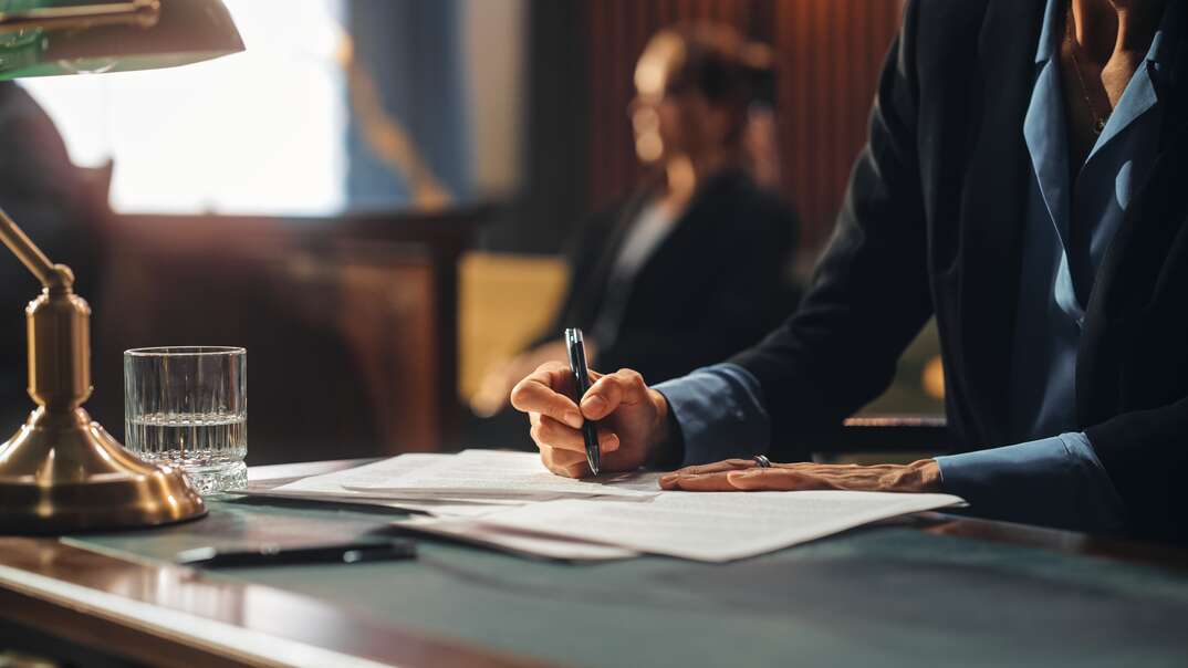 Female Public Defender Writes Down Arguments for Defense Strategy, public defender, lawyer, attorney, attorney at law, law, legal, court, courtroom, female lawyer, woman, desk, writing, taking notes, desk lamp, lamp