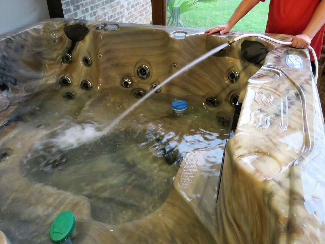 senior man cleaning hot tub