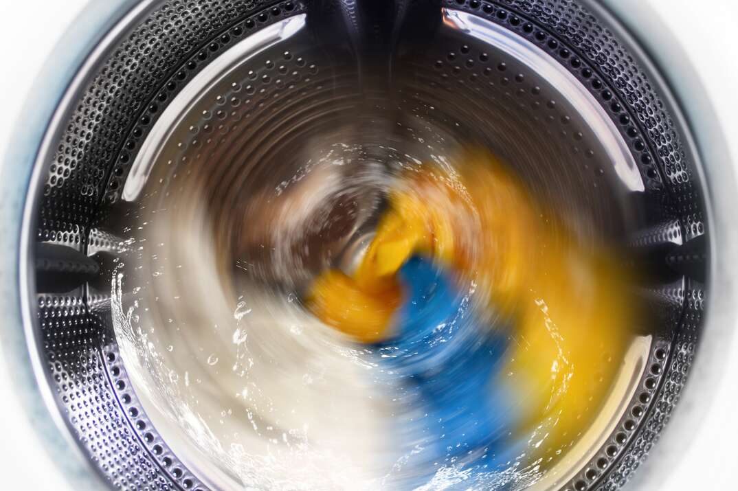 View inside the washing machine while washing laundry  Splashing water 