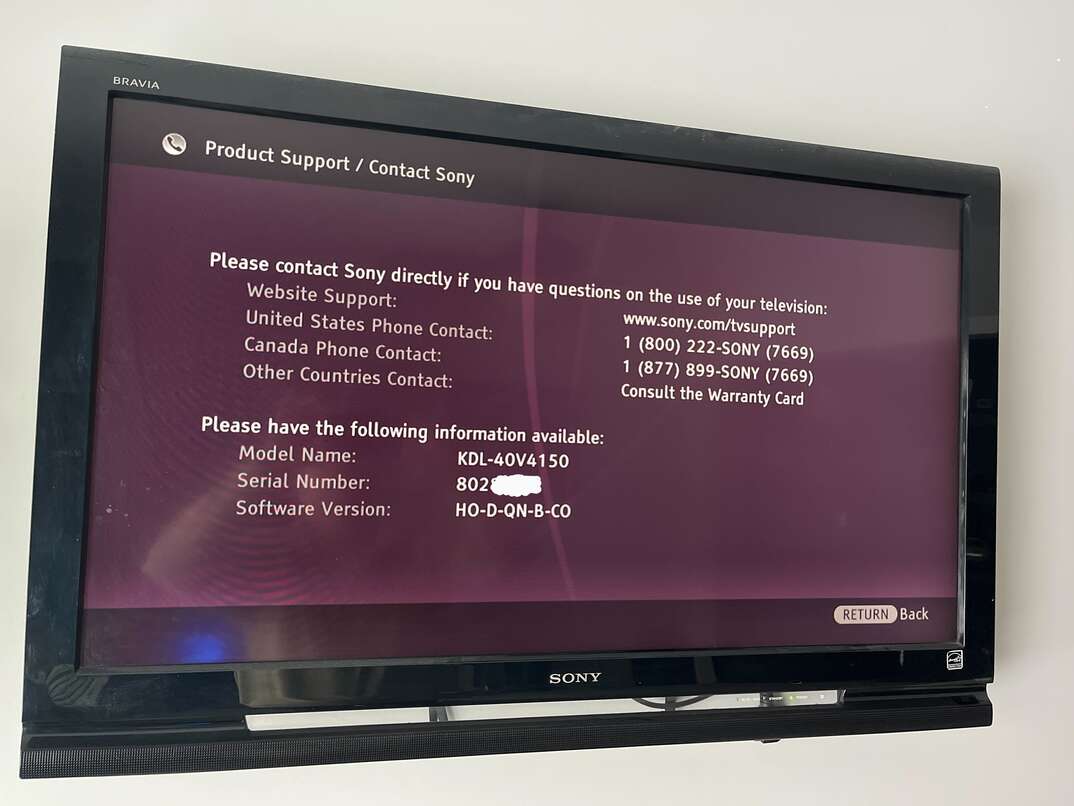 A black Sony brand flatscreen TV hangs on  the wall of a home