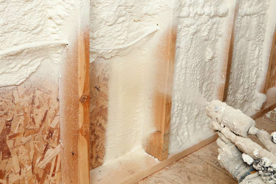 close up shot of spray foam being applied on to a wall