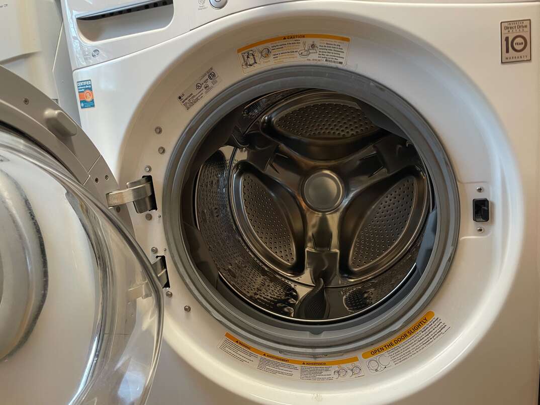 view inside of a white washing machine with the door open