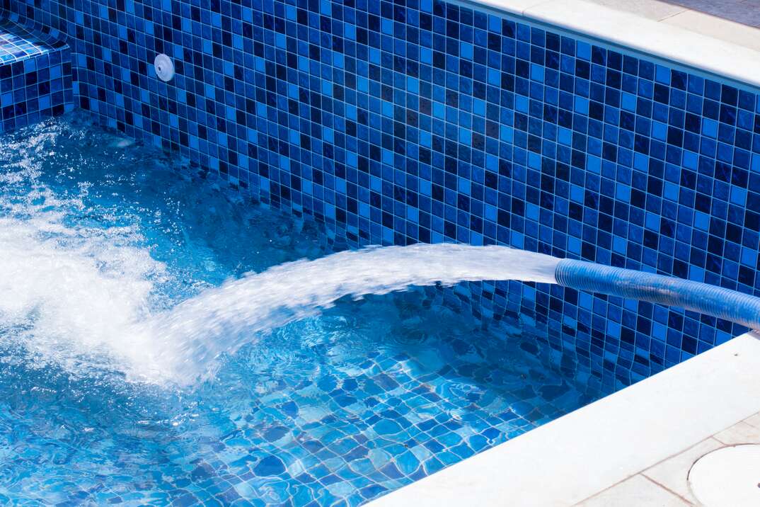 residential swimming Pool filling up with water through a hose