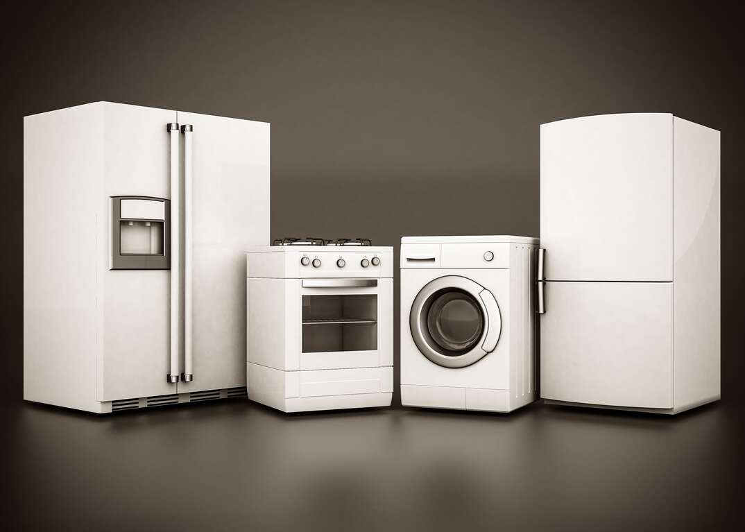 A group of white appliances including two refrigerators and an oven range and a washing machine are displayed against a gray background