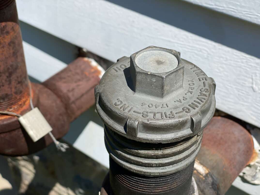 Oil heater tank pipe on exterior of home for filling