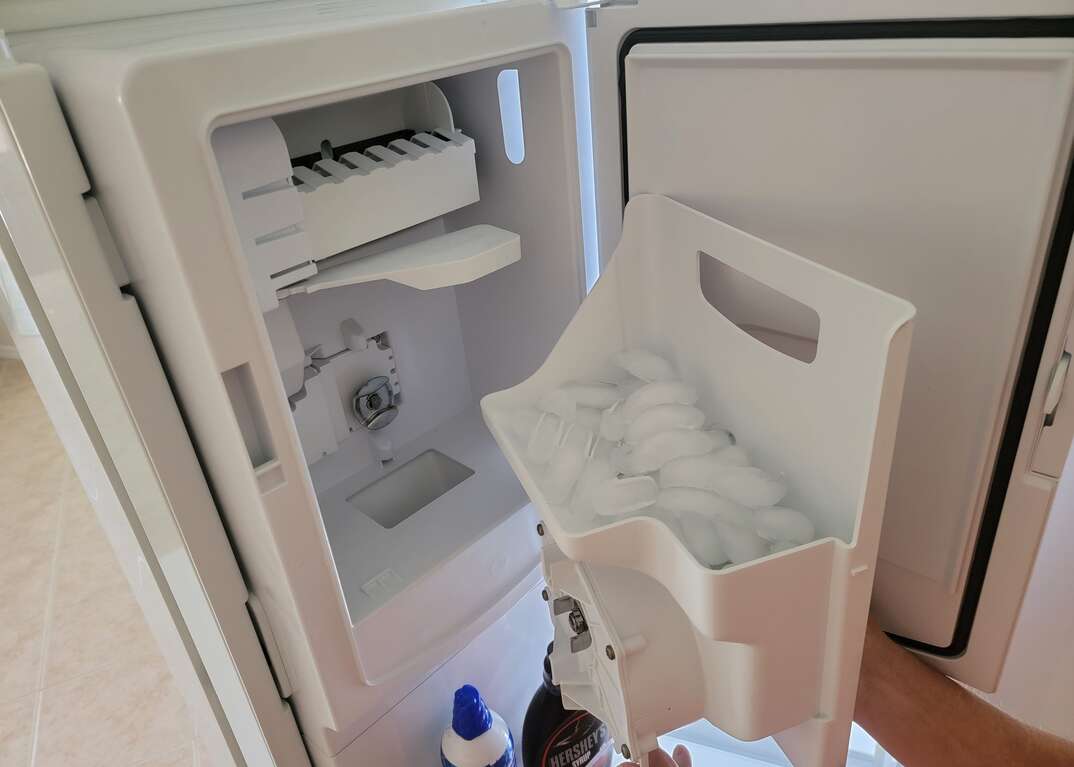 Opening refrigerator ice maker to clean
