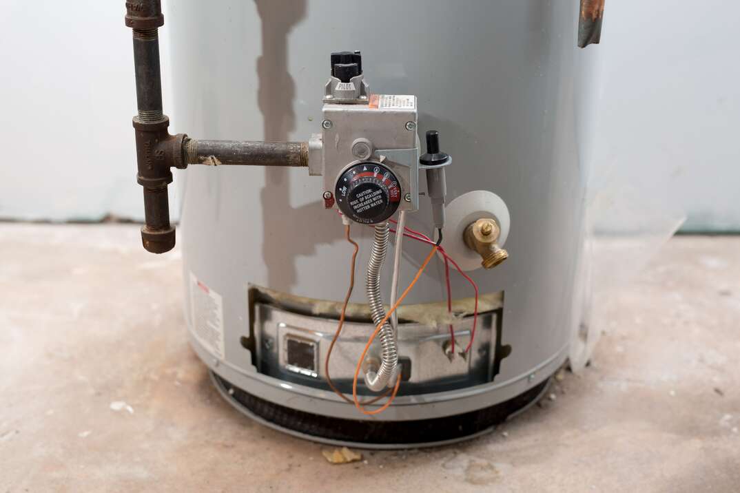 technician working on a water heater