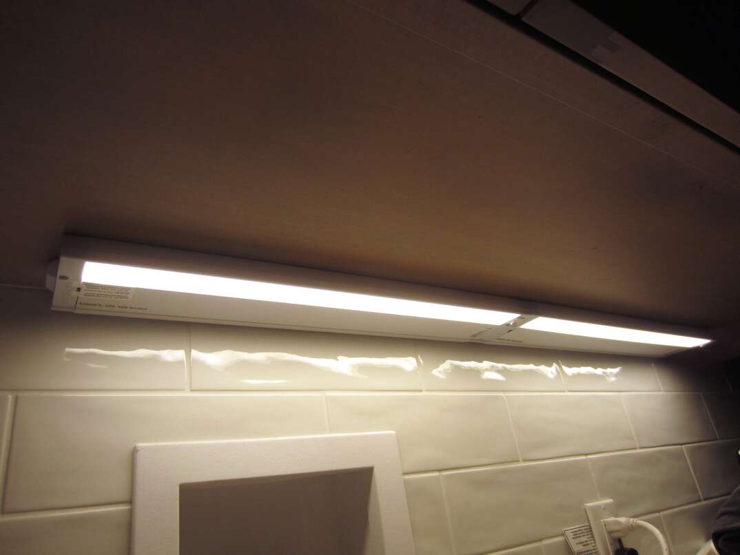 Under cabinet lighting by  laundry machine hookup
