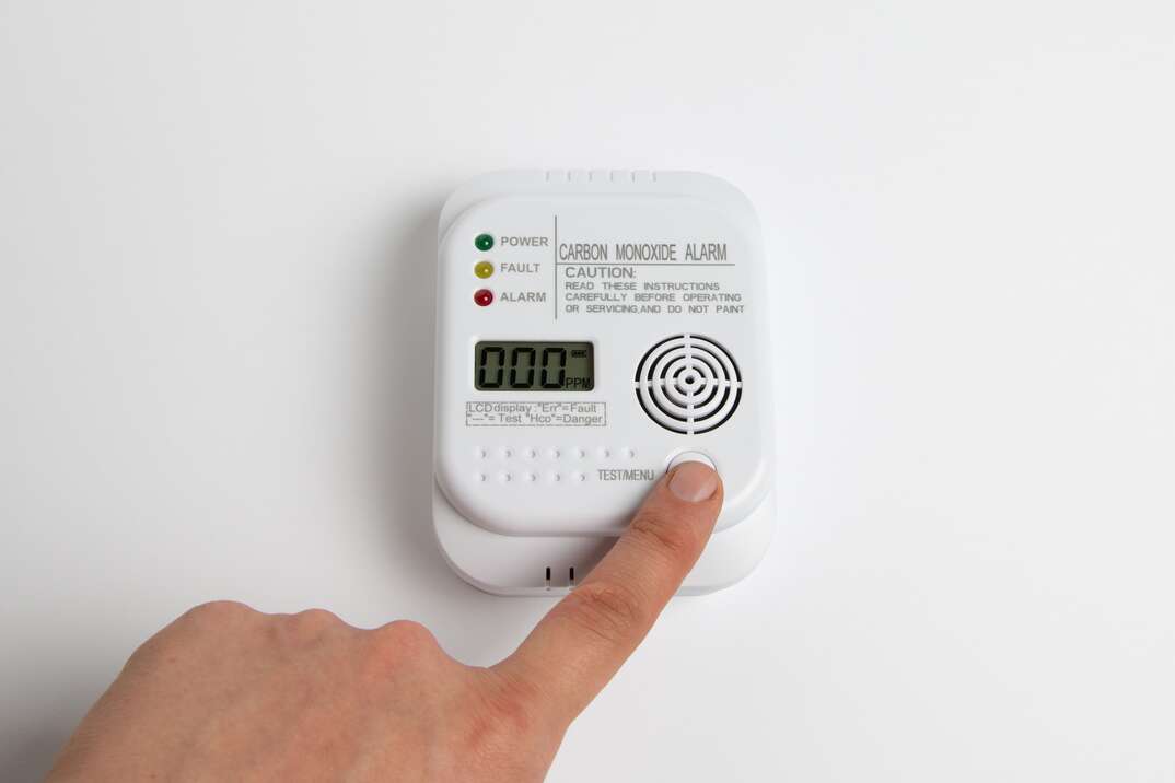 person testing carbon monoxide alarm