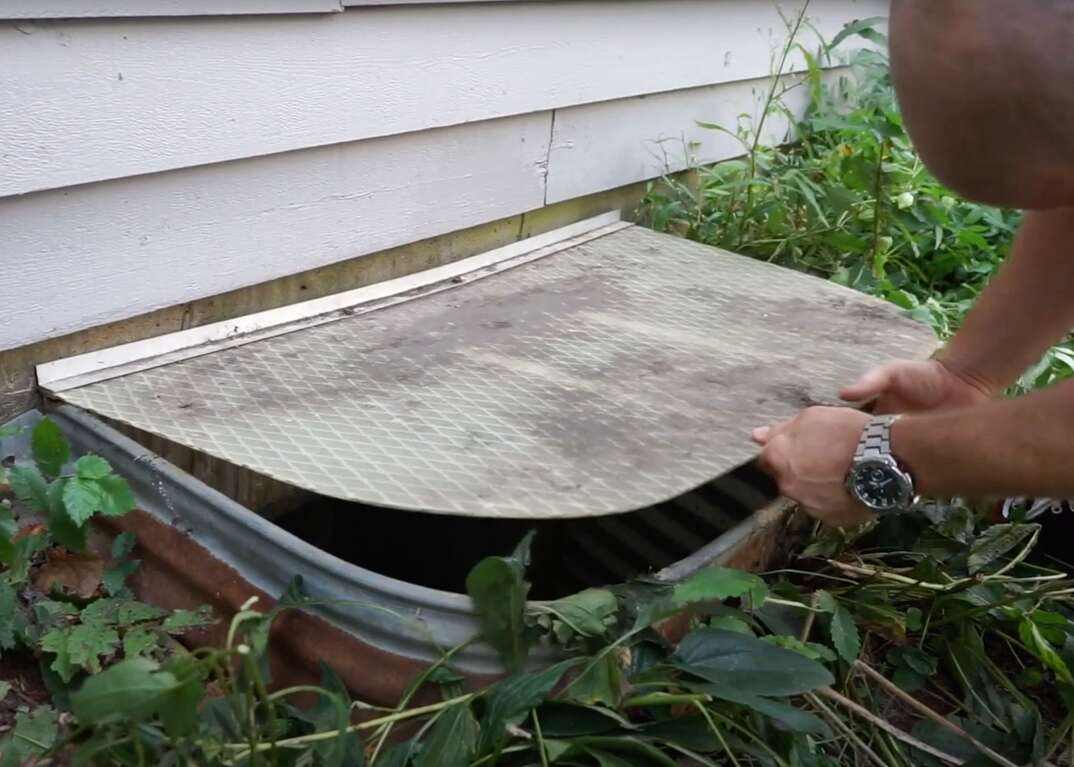 A window well leading to the basement egress window of a house