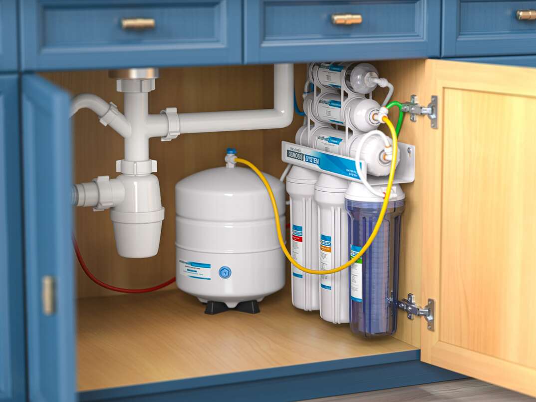 Reverse osmosis water purification system under sink in a kitchaen.  Water cleaning system installation. 3d illustration