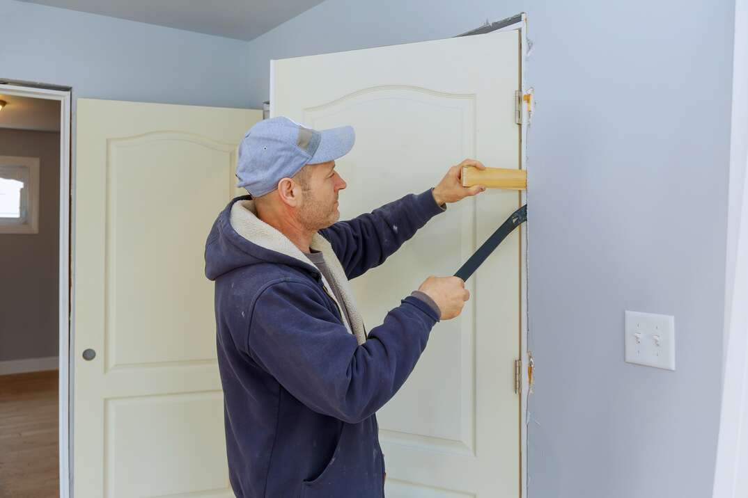Handyman install the new door in the interior room