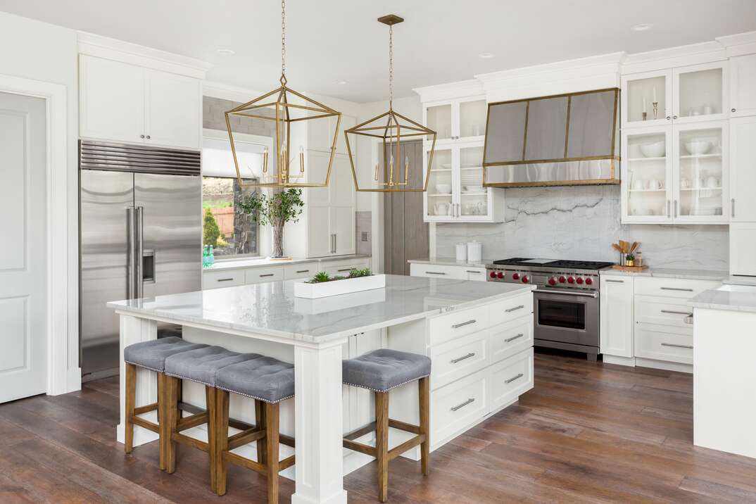 beautiful kitchen in new luxury home with a Marble island