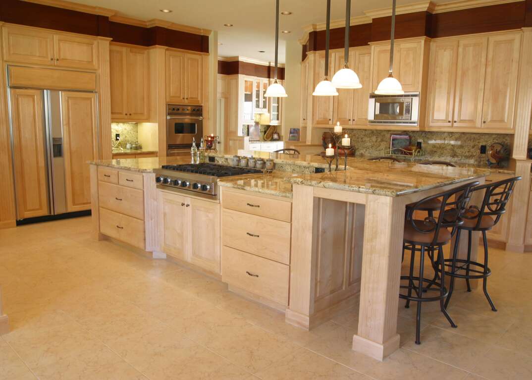 A built in refrigerator is displayed in a clean upscale domestic kitchen