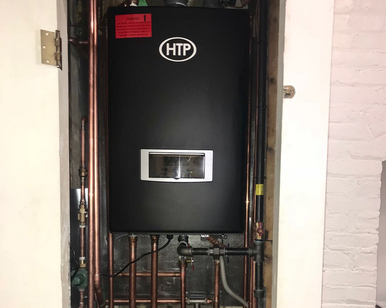 a new tankless hot water heater installed in a maintenance closet